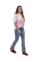 side view of a young girl walking and looking at camera on white background