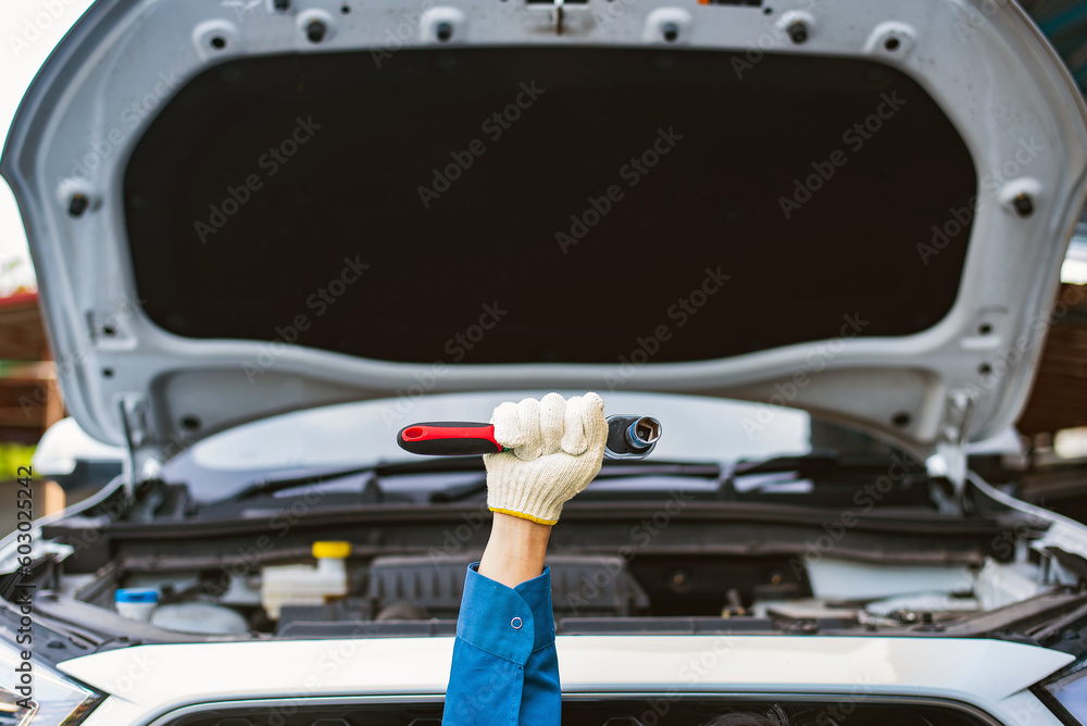 Poster close-up hand technician auto mechanic using the wrench to fix change spare part vehicle engine prob