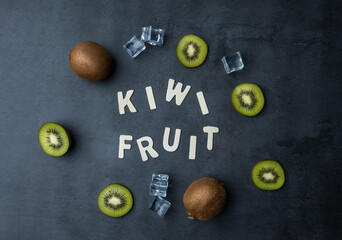 Kiwi fruit flat lay image with ice cubes and letters