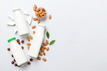 Set or collection of various vegan milk almond, coconut, cashew, on table background. Vegan plant based milk and ingredients, top view