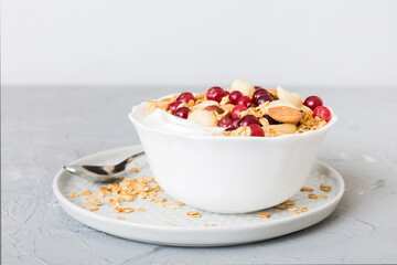 Healthy breakfast food with granola, yogurt, fruits and nuts. Dessert parfait with dried fruits for breakfast