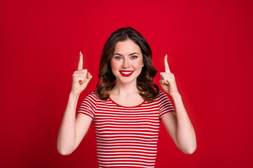 Photo of cute young lady directing fingers up empty space new lipstick pomade promotion banner...