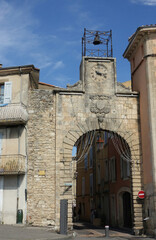 Fototapeta na wymiar Tower of the city gate in the main street of Apt, Vaucluse,France.