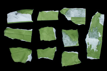 Set of green torn paper pieces isolated on black background. Ripped papers for your designs.