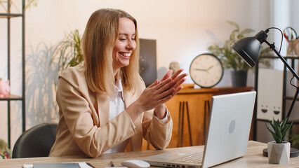 Sneaky cunning blonde young businesswoman with tricky face gesticulating and scheming evil plan,...