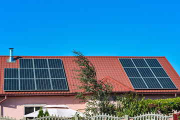 Solar panels on the roof of a country house, environmental production of solar energy in electrical.