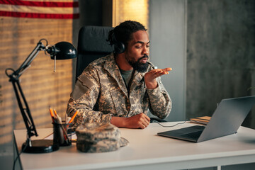 Army officer on video call with family.