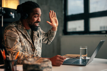 Cheerful soldier with family on video call.