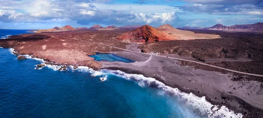 Foto op Canvas Volcanic Lanzarote island scenery. aerial  panoramic drone view  of Los Hervideros caves and cliffs and Red mountain . popular tourist destination Canary islands. © Freesurf