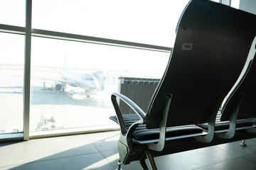 Armchairs are in the waiting room and the arrival of aircraft at the airport.