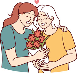 Woman hugs elderly mother and gives bouquet of flowers congratulating with birthday or mother day