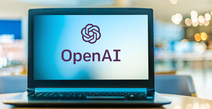 Laptop computer displaying logo of OpenAI