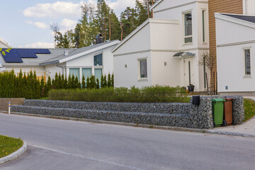 Beautiful exterior view of white modern houses with solar panels installed on roof. Sweden. 