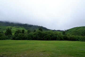 Fototapeta na wymiar Morning scenery with fog on the hills at the farm with a cool atmosphere to visit in Malaysia.