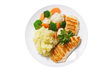 plate of grilled chicken, mashed potato and vegetables isolated on t background, top view