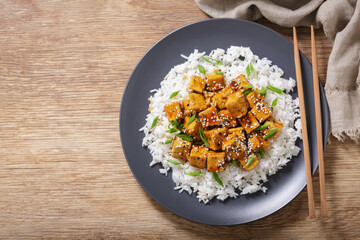 plate of rice and fried tofu with sesame seeds, top view