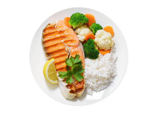 plate of grilled salmon steak, rice and vegetables isolated on transparent background, top view