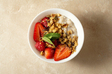 Oatmeal porridge with strawberry, homemade granola. Healthy breakfast.