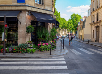 Cozy street with flower shop in Paris, France. Architecture and landmark of Paris. Cozy Paris cityscape