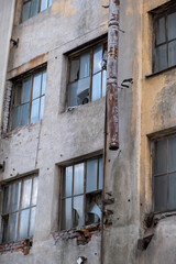 Fototapeta na wymiar Shattered windows on abandoned industrial building