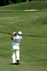 A golfer playing golf in the field.