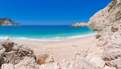  Petani Beach with white sand and azure water against blue sky - Kefalonia island, Ionian sea, Greece.