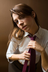 women at work: irritated businesswoman fixing her tie