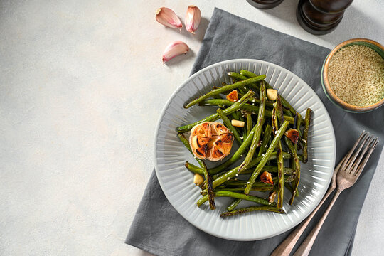 Roasted garlic green beans in grey plate. Top view, copy space