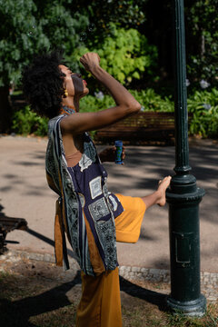 Woman in the park playing with bubble