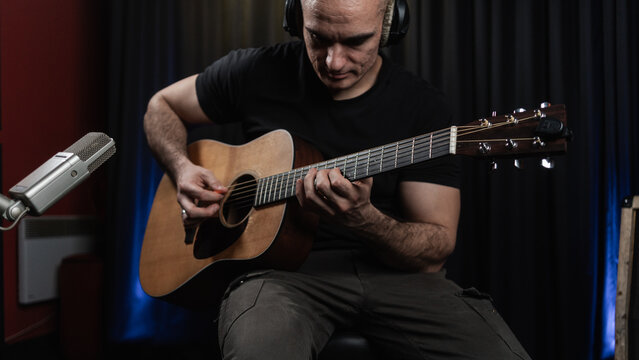 Artist Playing Guitar In The Music Studio