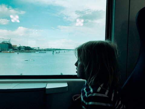 A kid in a train to Venice