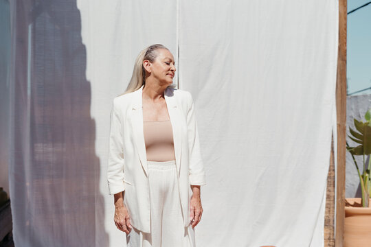 Joyful senior fashion woman at terrace