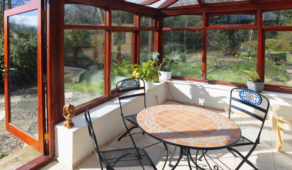 conservatory tables chairs plants room in house next to garden