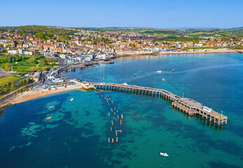High Tide rolls in around the Piers of Swanage Bay, Dorset, United Kingdom. Aerial Image.
