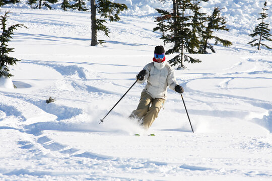 A skiier enjoying fresh snow in Whistler, BC.