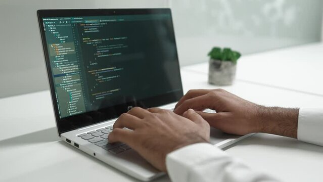 Close-up of screen where visible programming code for clients. Developing software of web sites, programs or apps on laptop. Working at office. Using technology. Developer concept.