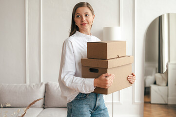 Calm woman with carton boxes in living room