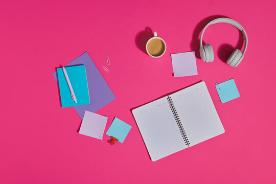 Office table with supplies. Headphones, cellphone with blank space