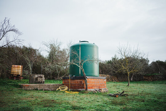 Green water tank in the countryside