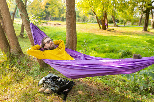 man relaxing in a hammock