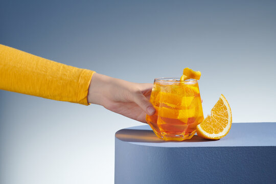 wine glass with refreshing cold drink decorated with fresh orange