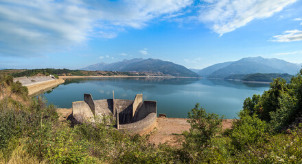 Obraz na płótnie Canvas Debar lake summer landscape with water drainage construction near Hydroelectric power plant Shpilje, and mountains background. North Macedonia not far from Debar Town, Europe.