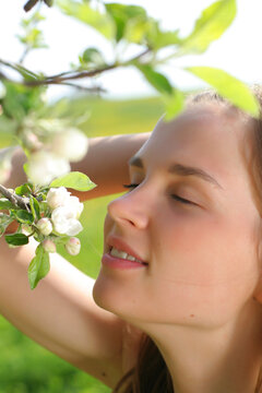 Girl holds apple flowers and smile - very cute portrait
