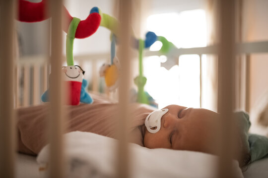 Sleeping infant baby lying in cot