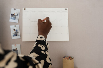 Faceless black businesswoman managing working hours