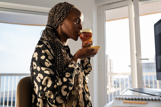 Black businesswoman drinking tea during break