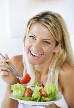 high-key portrait smiling female eating her salad