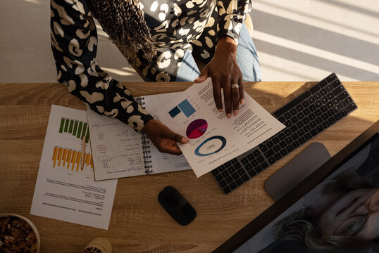 Female freelancer examining charts during consultation