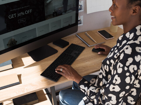 Black freelancer typing text on computer keyboard