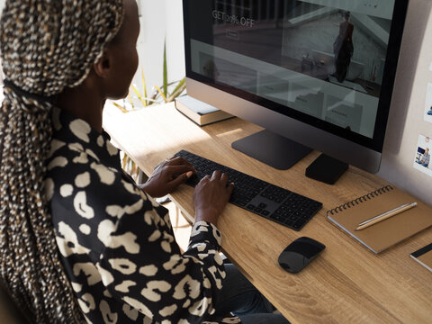 Black female freelancer creating project on computer